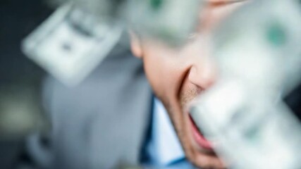 Financial Triumph: A man, immersed in a downpour of money, is enveloped in an environment that suggests prosperity and achievement