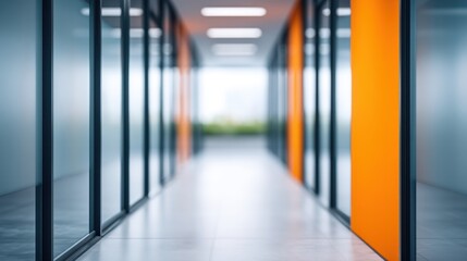 Fototapeta premium Modern corridor in a contemporary office showcasing glass walls and vibrant orange accents, emphasizing spaciousness and professional atmosphere