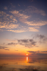 A minimalist landscape of a summer sunset at the beach of Baltic Sea. Colorful scenery in Latvia, Europe.