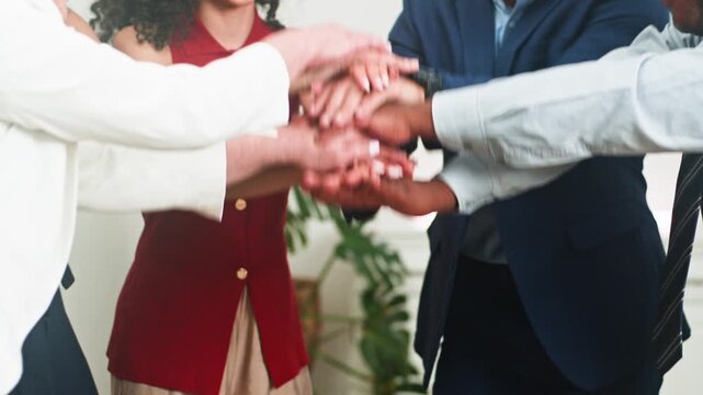 Diverse Business Team Celebrates Success with United Hands, Fostering Collaboration and Teamwork in the Office