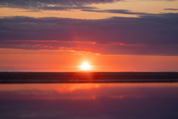 A baeuriful pink sunrise over the Baltic Sea. Summer morning at the beach. Latvia, Europe.