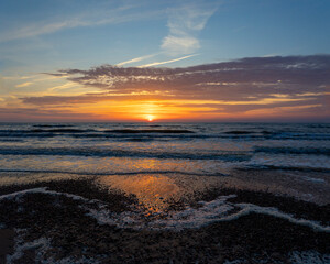 Obraz premium A beautiful, colorful summer sunset over the Baltic Sea. Summer evening at the beach in Latvia, Europe.