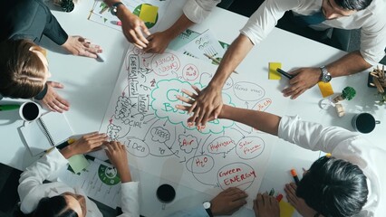 Top view of professional business team working together to brainstorm environmental idea by using mind map. Aerial view of smart manager talking and discussing about sustainable energy. Alimentation.