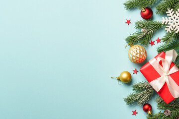 Christmas present with decor on blue with space for design.