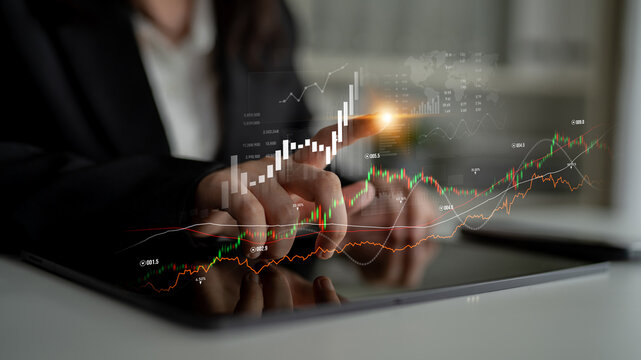 Professional analyzes financial graphs and indicators on a tablet in a modern office, showcasing technology impact on business strategy and growth insights. Scalp
