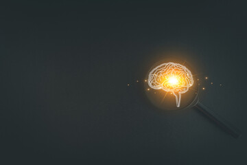 Magnifying glass focusing on a glowing human brain icon, symbolizing the search for ideas,...