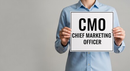 Person holding CMO Chief Marketing Officer sign, leadership role, marketing executive hiring concept.