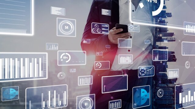 A business professional stands in a modern urban environment, engaging with a smartphone amidst a dynamic display of digital data and analytics visuals. Xenic
