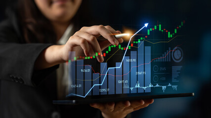 A business professional interacts with a tablet to analyze stock market data, showcasing financial growth and trends through advanced technology and visualization techniques. Scalp