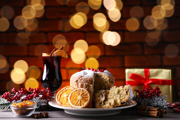 Christmas food. Delicious Panettone cake and festive decor on wooden table, closeup