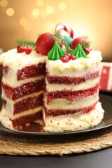 Tasty cake with Christmas decor on black table against blurred lights, closeup