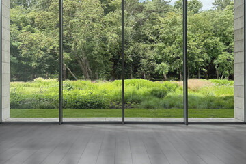 Floor-to-ceiling window with garden view in empty spacious room. Interior design