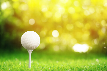 Golf ball and tee on green grass outdoors