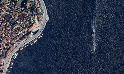 Aerial satellite view showing cargo ships navigating across the blue ocean — high-resolution imagery highlighting maritime transport and global trade routes