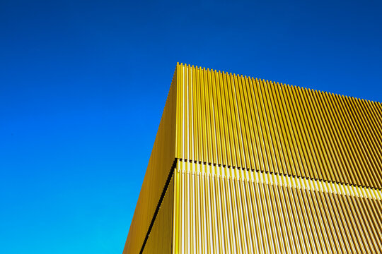 golden facade of the lenbachhaus under deep blue sky