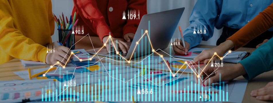 Diverse business team collaborates on data analysis using charts and graphs in a modern workspace filled with colorful stationery and creative ideas. Scalp