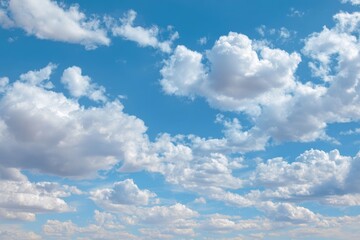 Fluffy white clouds drifting in serene blue sky, capturing tranquil beauty and peacefulness of nature's calming atmosphere for relaxation and inspiration