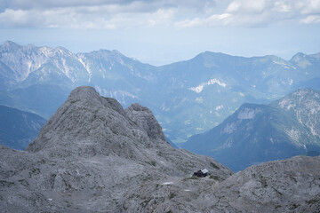 Landscape with solitary mountain hut located on a rocky alpine terrain, Triglav Nat Park, Slovenia