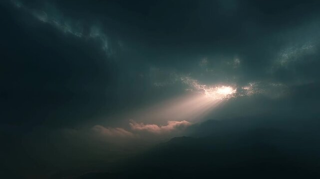 Sunlight breaks through the dark storm clouds, creating a dramatic sky scene