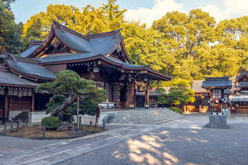 Naklejka premium Traditional Japanese Shinto Shrine with Wooden Architecture and Garden