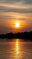 Naklejka premium Golden Hour Reflections - Serene Sunset Over Still Waters.