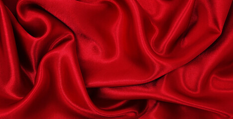 Smooth elegant red silk or satin luxury cloth texture as abstract background. Luxurious valentines day background design