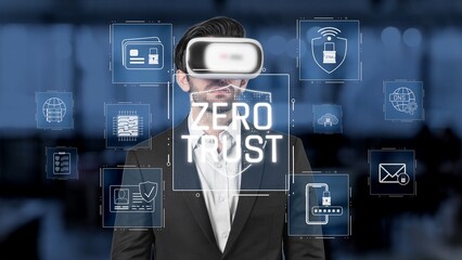 A professional man wearing a virtual reality headset stands amidst digital security symbols, emphasizing a zero trust approach vital for modern cybersecurity strategies. Raster
