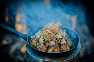 Delicious takoyaki topped with bonito flakes, steaming and inviting, captures culinary delight