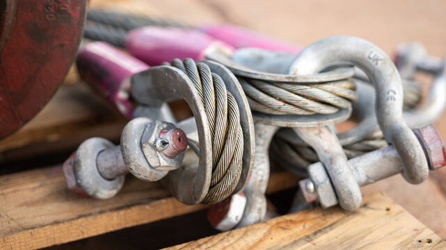 Wire rope sling and shackle device, equipment for heavy lifting in crane operation, there are in brand new condition. Industrial equipment object with close-up.