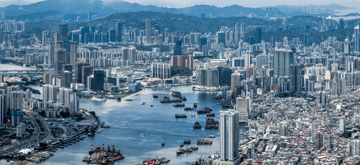 High angle telephoto view of the dense urban architecture and crowded inner harbor with many boats...