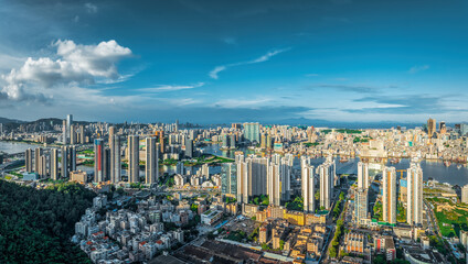 High angle view of a dense residential district with modern high-rise buildings and a river in...