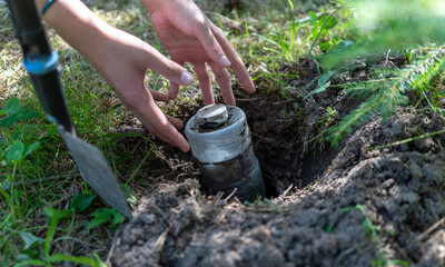 Find a bottle with a treasure in the ground.A message from the past in a bottle.A time capsule.