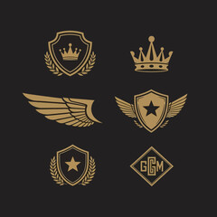 Collection of golden heraldic emblems with crowns, wings, shields, and stars.