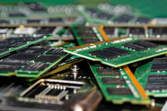 A stack of old SDRAM memory modules lying on a printed circuit board.