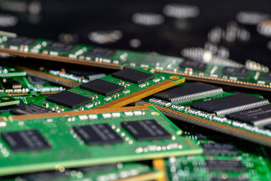 A stack of old SDRAM memory modules lying on a printed circuit board.