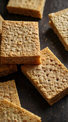 Wheat Thins crackers stacked on a dark surface