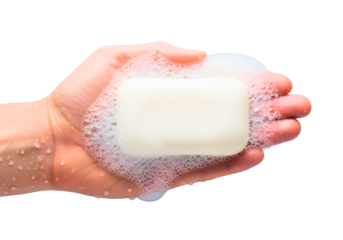 Hand holding a bar of soap with suds isolated on transparent background