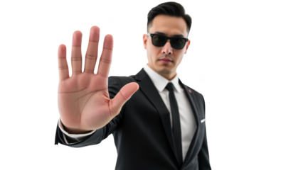 Professional man in suit with sunglasses, signaling to stop. Confident demeanor, urban background, conveying authority and security
