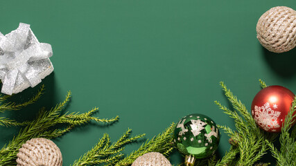 christmas decoration and christmas tree branches on a green background,christmas background with...