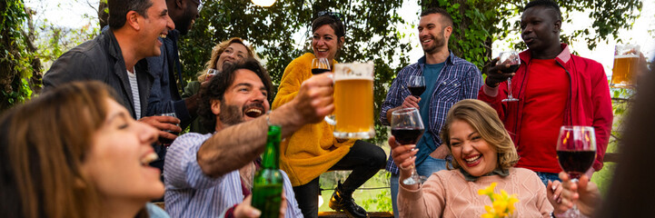 happy people toasting drink glasses sitting bar table – friends toasting red wine and beer on...