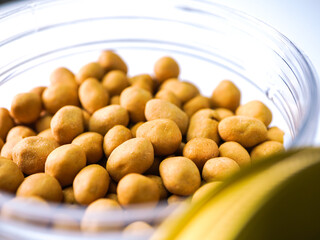 Crispy seasoned peanuts piled high in a clear bowl, a delicious snack perfect for sharing and enjoying any time.