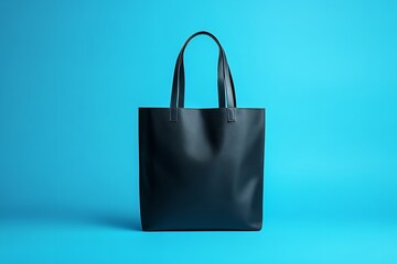 Elegant black tote bag on vibrant blue background for your everyday essentials, perfect for shopping, travel, or stylish organization in a modern way
