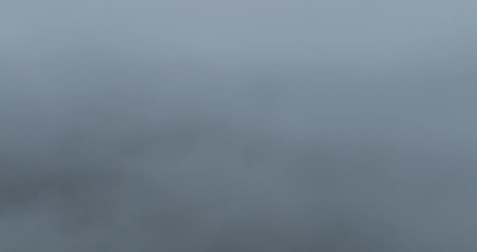 Aerial footage of arising fog in beautiful forest mountain landscape