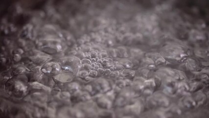 Closeup shot of water boiling in pan.