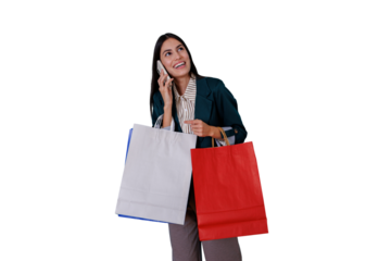 Woman standing, smiling, talking on a smartphone while holding shopping bags. She is enjoying an active lifestyle