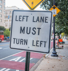 Left Lane Must Turn Left road sign in downtown Washington DC