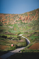 Winding Road Through Lush Green Valley and Red Rock Cliffs, Tenerife, Canary Islands