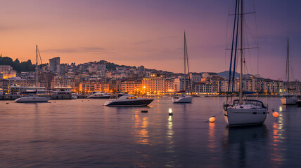 Sailboats and yachts in harbor at dusk with city skyline marina