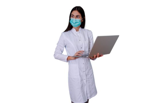 Medical professional, a young woman, wearing lab coat and face mask, holding and using a silver laptop on transparent background