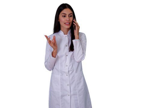 Woman doctor or medical professional in a lab coat conversing on a smartphone and gesturing, showing remote consultation